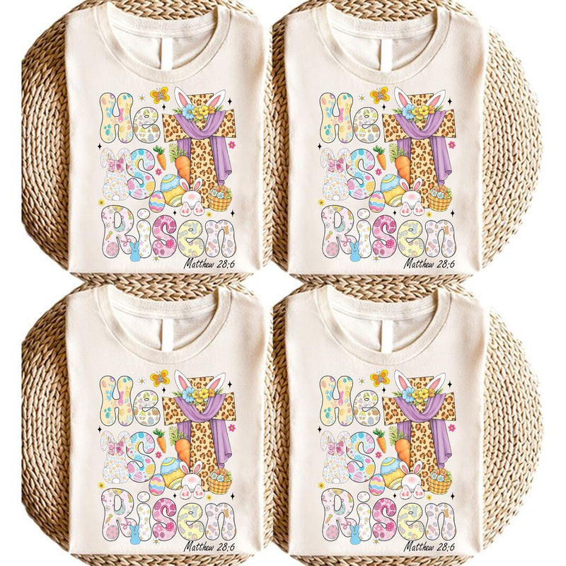 Christliches Oster-Shirt „He is Risen“ mit Leo-Kreuz, Osterhase und Blumen
